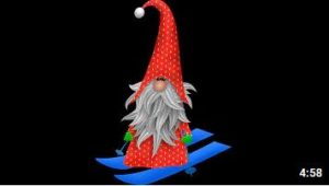 Gnome dressed in red on blue skiis
