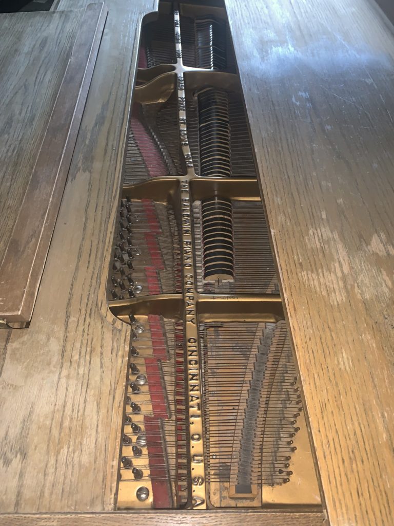 Piture of the soundboard of a 1930's Baldwin where the strings attach to the tuning pegs.